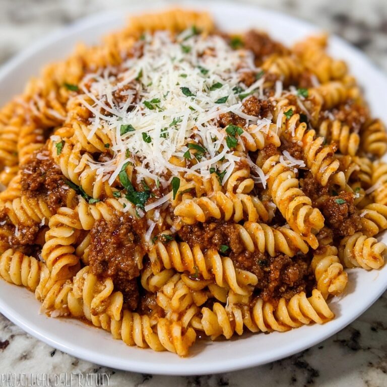 Cheesy Garlic Twisted Pasta with Cajun Ground Beef and Alfredo Velveeta Recipe